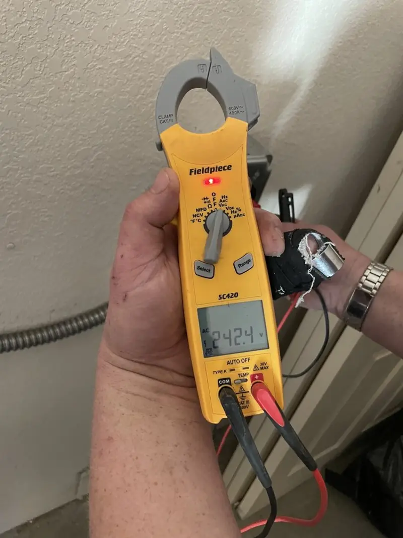 Voltage testing with clamp meter during Outlet Installation in Chestnut Ridge